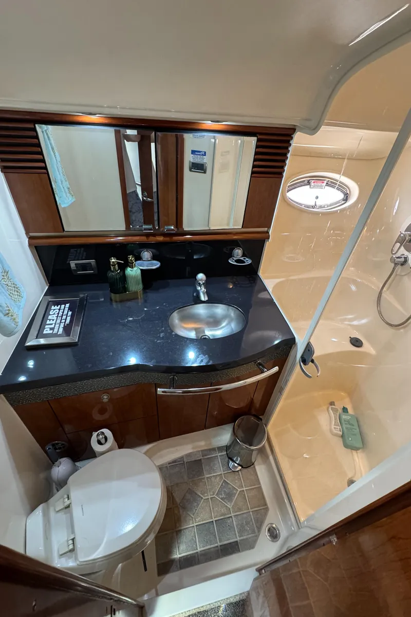 Slide: The Image of 2004 Sea Ray 500 Sundancer bathroom with sink, toilet, and shower. - 15