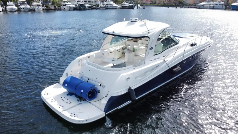 Slide: The Image of 2004 Sea Ray 500 Sundancer yacht cruising on a calm marina. - 4