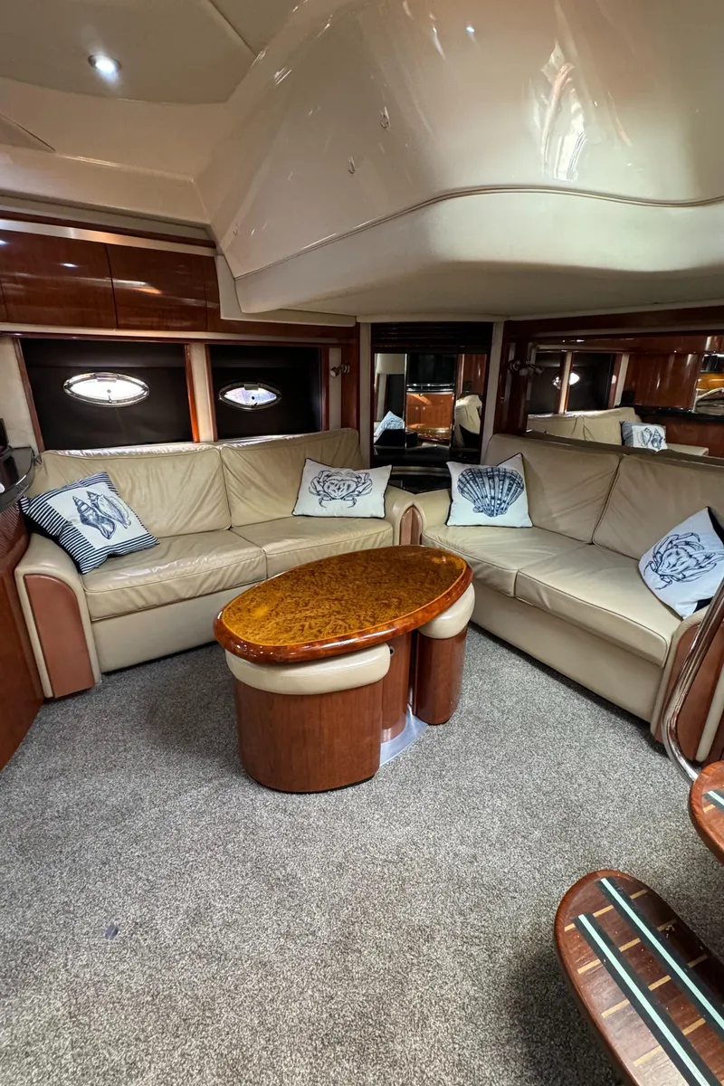 Slide: The Image of Luxurious interior of 2004 Sea Ray 500 Sundancer yacht with plush seating and elegant table. - 8