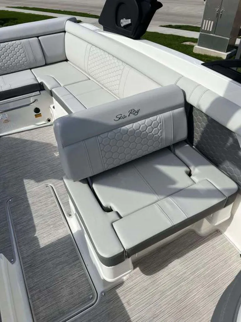 Slide: The Image of 2024 Sea Ray SDX 270 boat interior with gray cushioned seating and stylish design. - 8