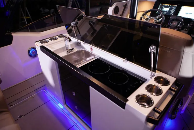 Slide: The Image of Modern kitchen area on the 2024 Saxdor 320 GTO boat with sink and stove. - 12
