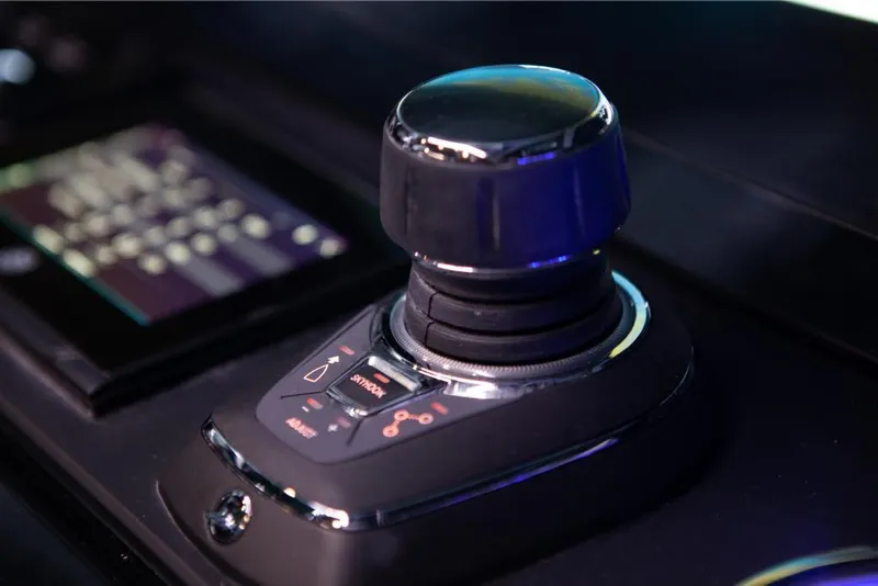 Slide: The Image of Close-up of the 2024 Saxdor 320 GTO control joystick and touchscreen interface. - 18