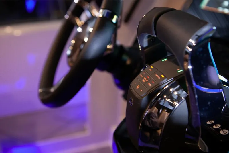 Slide: The Image of Close-up of the 2024 Saxdor 320 GTO steering wheel and throttle controls. - 22
