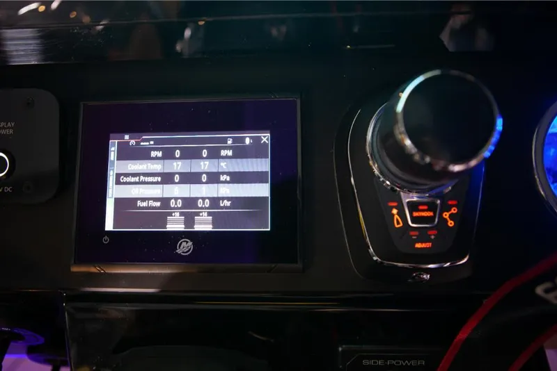 Slide: The Image of Close-up of the 2024 Saxdor 320 GTO dashboard display and controls. - 28