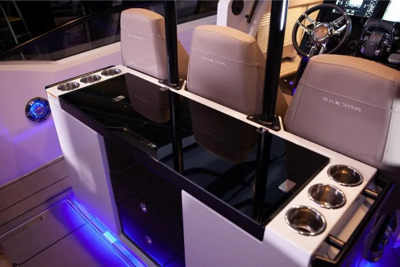 Slide: The Image of Interior of 2024 Saxdor 320 GTO boat with modern seating and cup holders. - 9