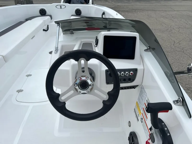 Slide: The Image of 2024 Tahoe T18 boat dashboard with steering wheel and control panel. - 3