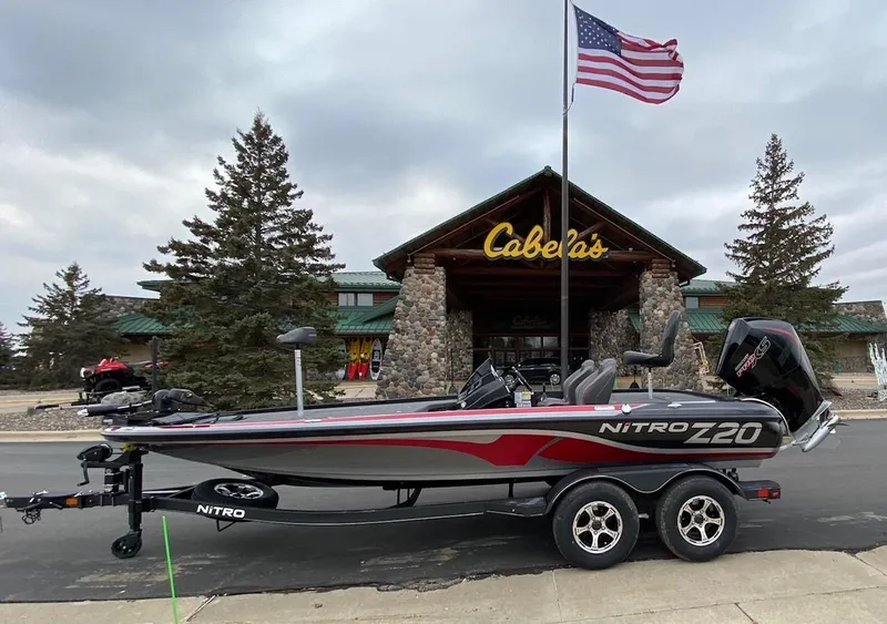 The Image of 2024 Nitro Z20 boat parked outside Cabela's store with American flag. - 0