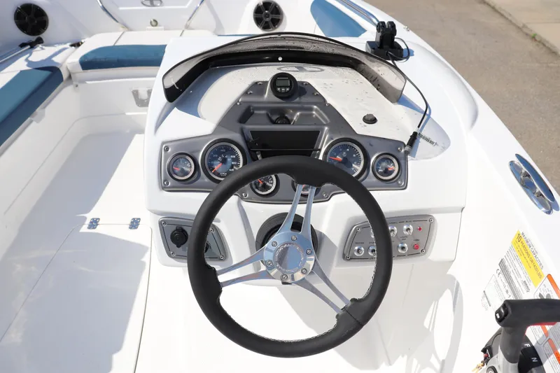 Slide: The Image of 2024 Tahoe 1950 boat dashboard with steering wheel and instrument panel. - 10