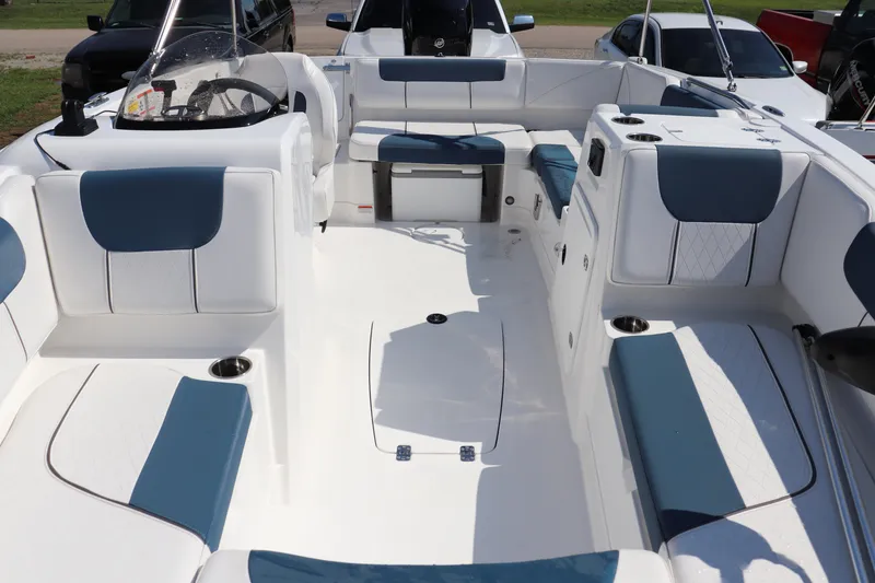 Slide: The Image of 2024 Tahoe 1950 boat interior with white and blue seating, spacious layout, and modern design. - 3