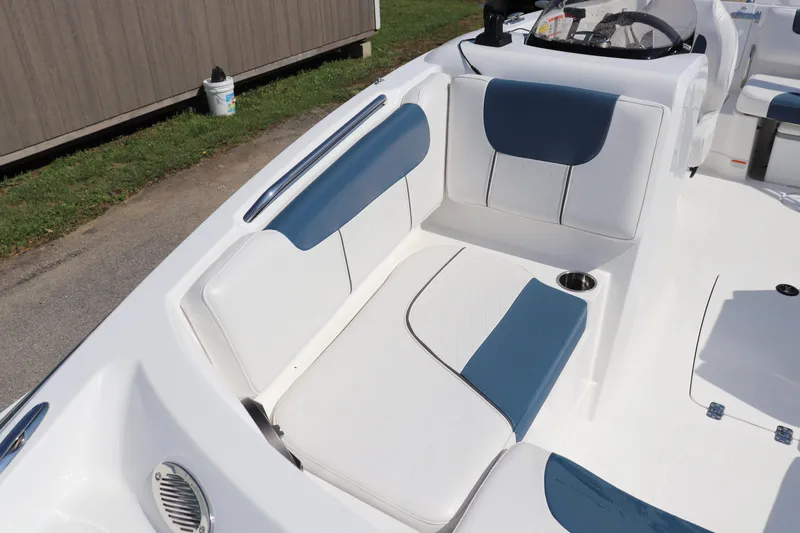 Slide: The Image of 2024 Tahoe 1950 boat interior with blue and white seating, cup holder, and steering wheel. - 4