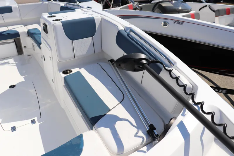Slide: The Image of 2024 Tahoe 1950 boat interior with blue and white seating, cup holder, and trolling motor. - 5