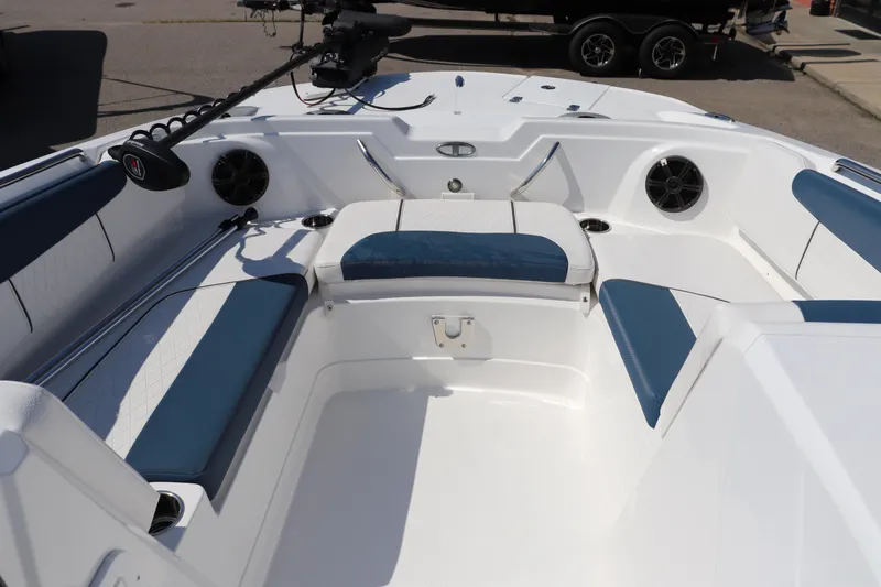 Slide: The Image of 2024 Tahoe 1950 boat interior with blue and white seating, speakers, and fishing rod holder. - 6