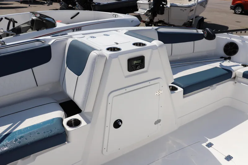 Slide: The Image of 2024 Tahoe 1950 boat interior with blue and white seating, cup holders, and storage compartment. - 9