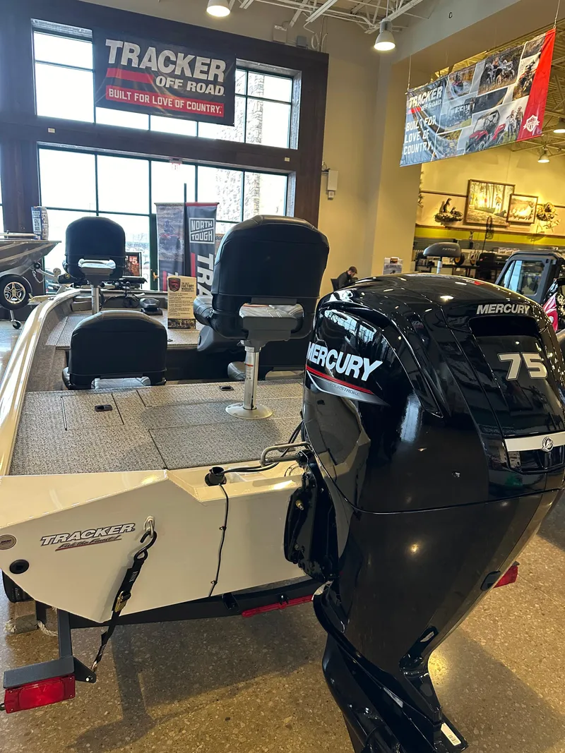 Slide: The Image of 2024 Tracker Pro Team 175 TF boat with Mercury 75 engine in showroom. - 3