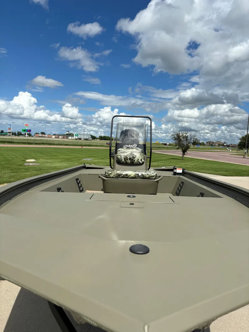 Slide: The Image of 2024 Tracker Grizzly 1860 CC boat on display under a blue sky. - 3