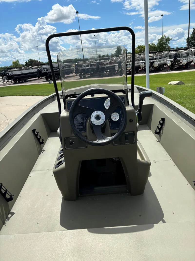 Slide: The Image of 2024 Tracker Grizzly 1860 CC boat interior with steering console. - 4