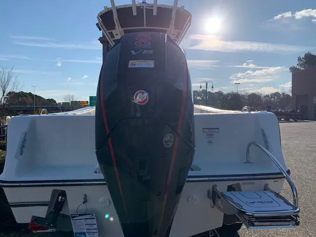 Slide: The Image of 2024 Mako 214 CC boat with powerful outboard motor in a sunny outdoor setting. - 1