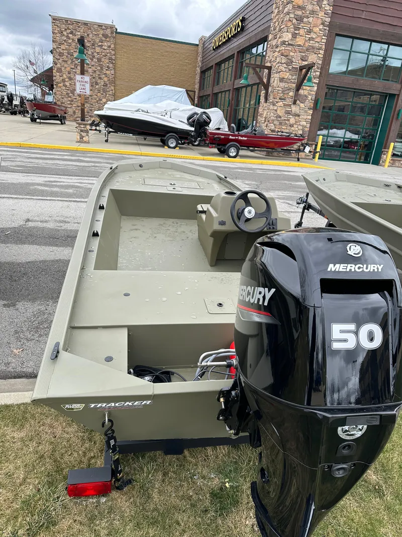 Slide: The Image of 2024 Tracker Grizzly 1648 SC boat with Mercury 50 engine displayed outdoors. - 2