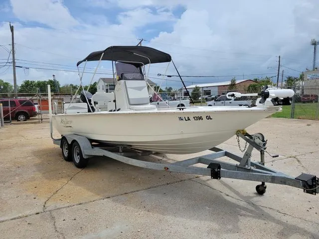Slide: The Image of 2019 Key Largo 220 BAY boat on a trailer in a parking lot. - 6