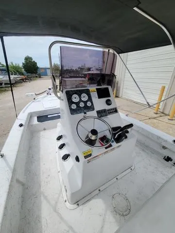 Slide: The Image of 2019 Key Largo 220 BAY boat cockpit with steering wheel and control panel. - 9