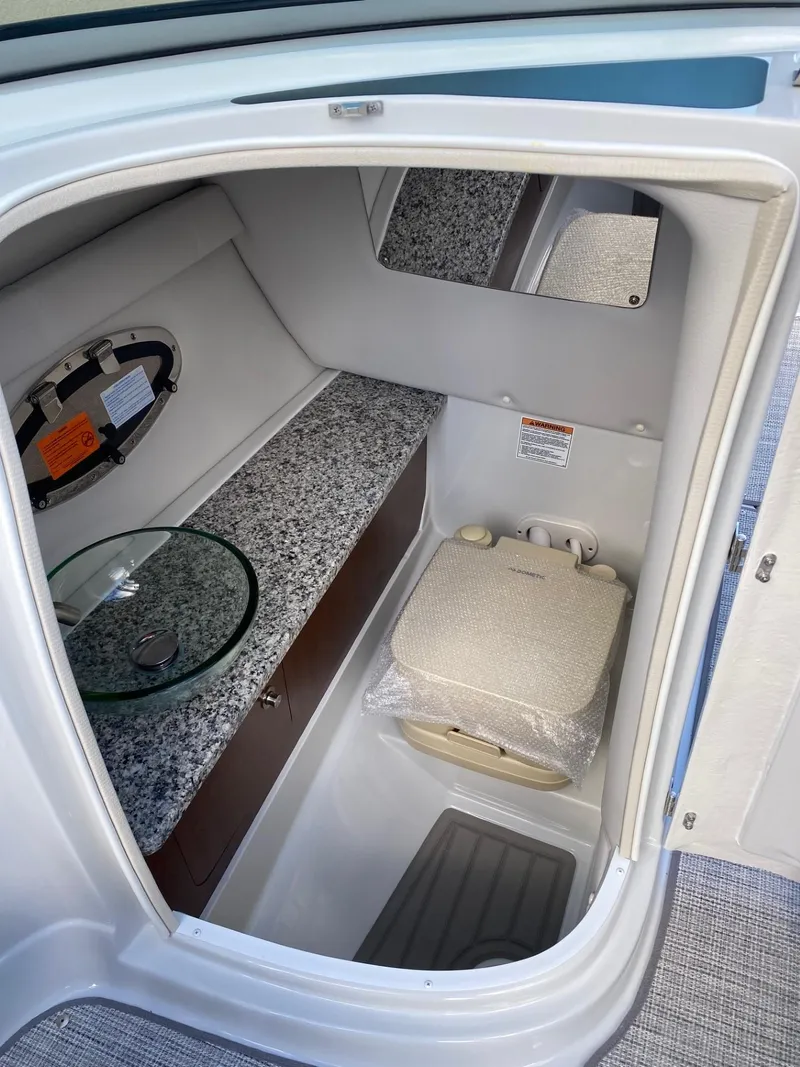 Slide: The Image of 2024 Crownline 250 XSS boat interior with modern bathroom amenities. - 11