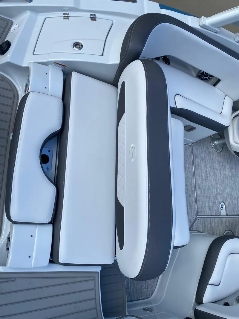 Slide: The Image of 2024 Crownline 250 XSS boat interior with white and gray seating. - 6