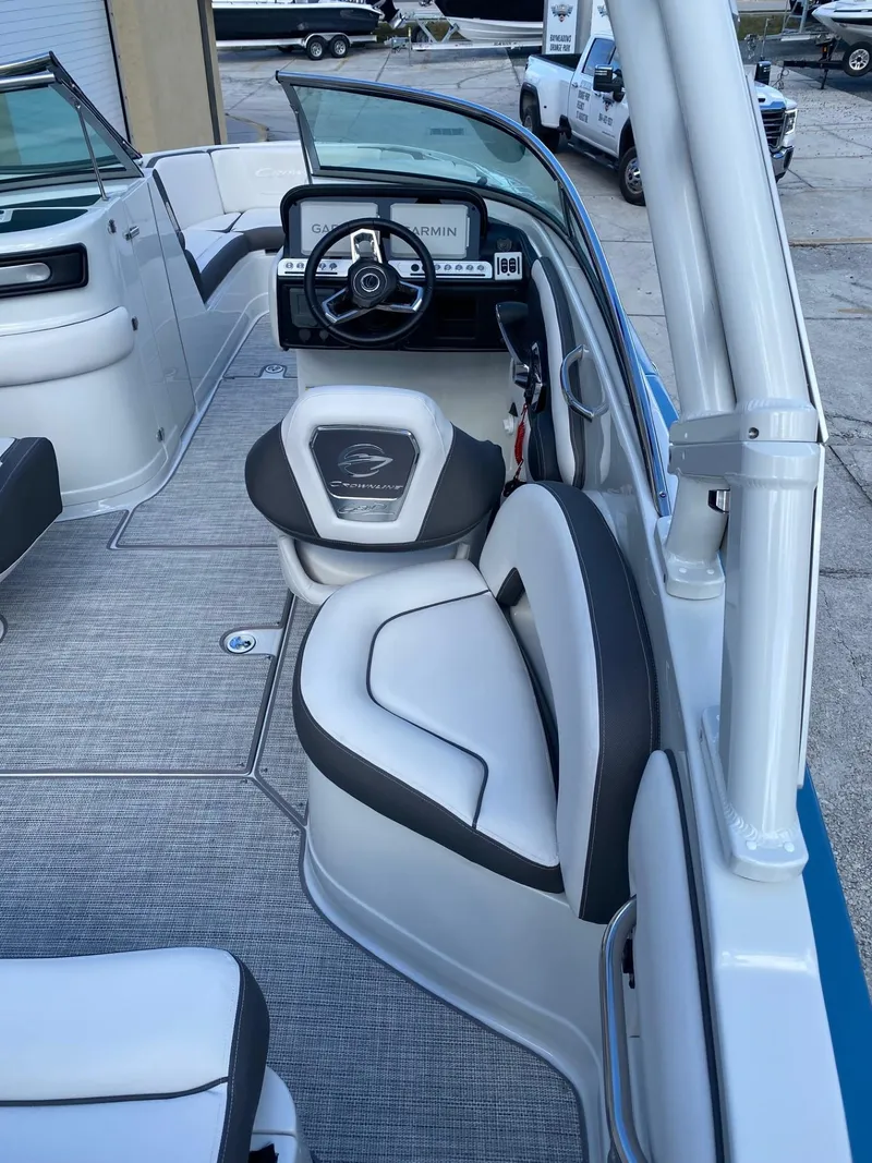 Slide: The Image of 2024 Crownline 250 XSS boat interior with helm and seating. - 8