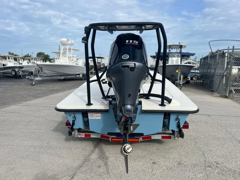 Slide: The Image of 2024 Maverick 18 HPX-V boat with 115 HP engine, rear view in marina. - 6