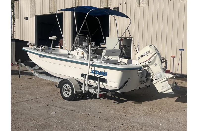 Slide: The Image of 2008 Sundance B18CC boat with Evinrude motor on trailer. - 3