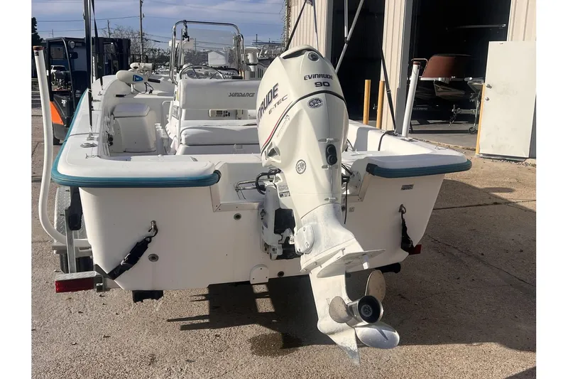 Slide: The Image of 2008 Sundance B18CC boat with Evinrude 90 outboard motor, docked at a marina. - 4