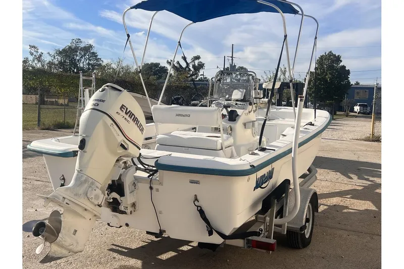 Slide: The Image of 2008 Sundance B18CC boat with Evinrude motor on trailer. - 5
