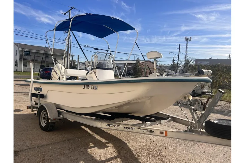Slide: The Image of 2008 Sundance B18CC boat on trailer with blue canopy in sunny outdoor setting. - 7