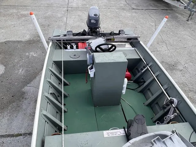 Slide: The Image of 2020 Southfork 1552 boat interior with steering console and motor. - 11