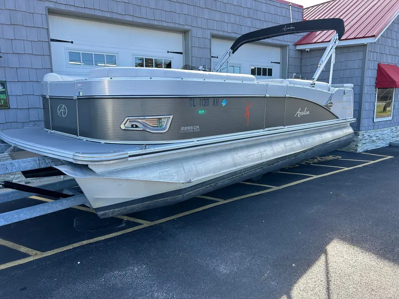 Slide: The Image of 2014 Avalon 2285 Catalina Cruise Twin Toon pontoon boat parked outside. - 0