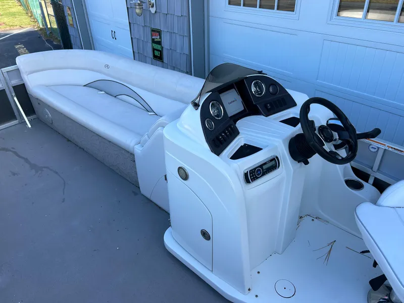 Slide: The Image of 2014 Avalon 2285 Catalina Cruise Twin Toon boat interior with helm and seating. - 11