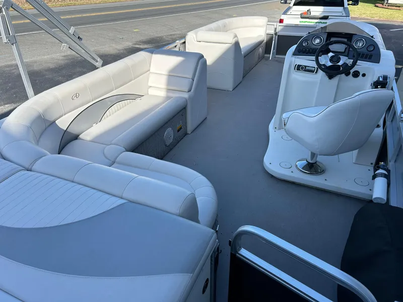 Slide: The Image of 2014 Avalon 2285 Catalina Cruise Twin Toon boat interior with white seating and helm. - 13