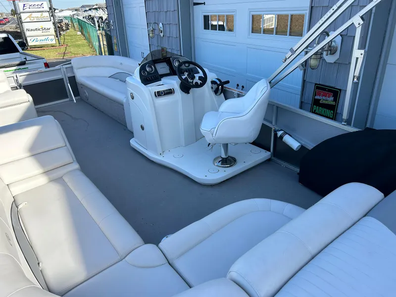 Slide: The Image of 2014 Avalon 2285 Catalina Cruise Twin Toon boat interior with white seating and captain's chair. - 14