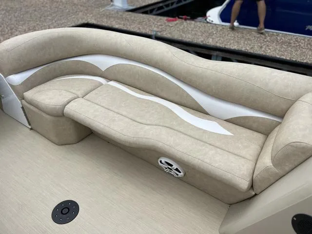 Slide: The Image of 2024 Aloha 230 Club Series boat with beige cushioned seating and integrated speaker. - 11