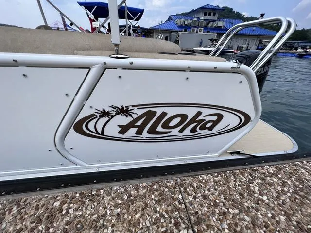 Slide: The Image of 2024 Aloha 230 Club Series boat docked at marina with logo visible. - 14