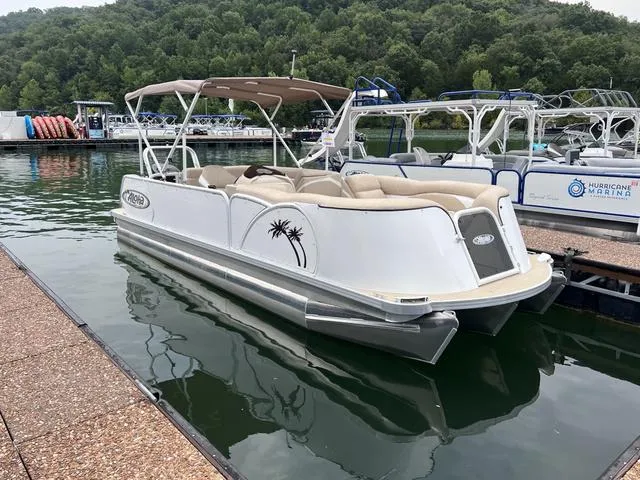 Slide: The Image of 2024 Aloha 230 Club Series pontoon boat docked on a serene lake. - 15