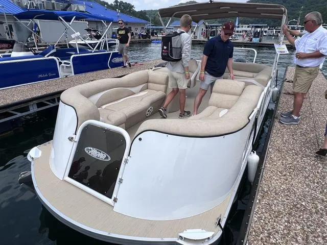 Slide: The Image of 2024 Aloha 230 Club Series pontoon boat docked with people onboard. - 3