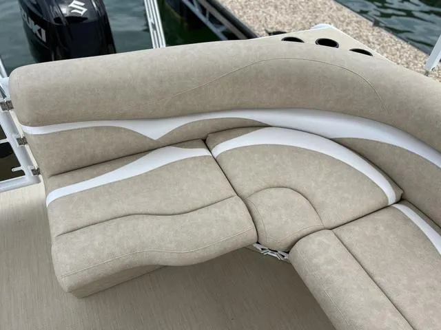 Slide: The Image of Luxurious seating on 2024 Aloha 230 Club Series boat, featuring beige and white upholstery. - 9