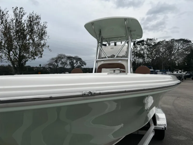 Slide: The Image of 2024 Pioneer 220 Bay Sport boat on trailer, overcast sky background. - 10