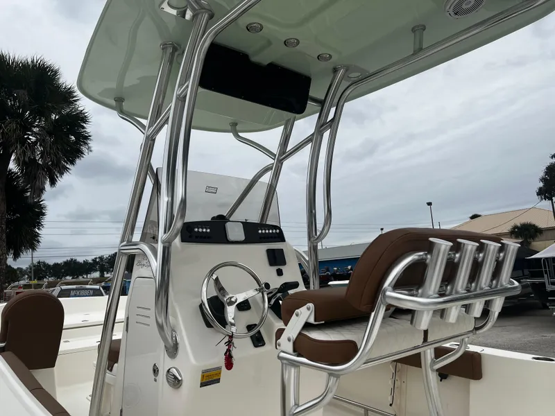 Slide: The Image of 2024 Pioneer 220 Bay Sport boat interior with steering console and seating. - 12