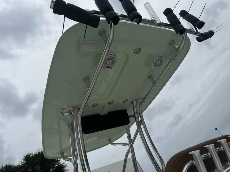 Slide: The Image of 2024 Pioneer 220 Bay Sport boat T-top with rod holders and speakers. - 13