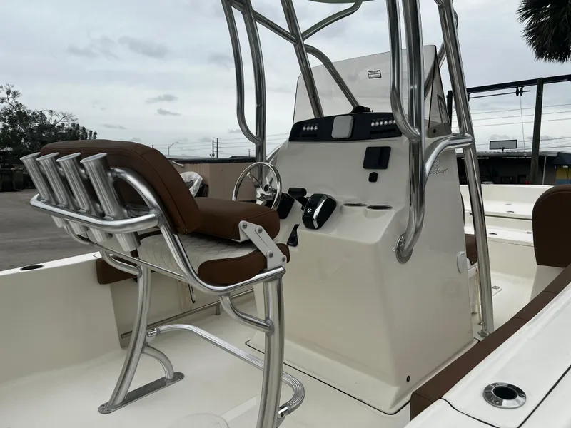 Slide: The Image of 2024 Pioneer 220 Bay Sport boat interior with helm and seating. - 14
