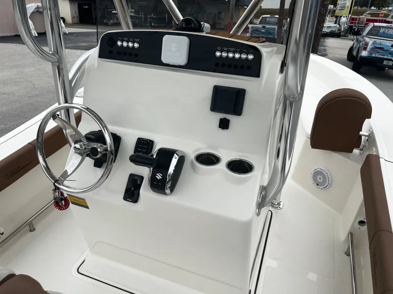 Slide: The Image of 2024 Pioneer 220 Bay Sport boat console with steering wheel and controls. - 17