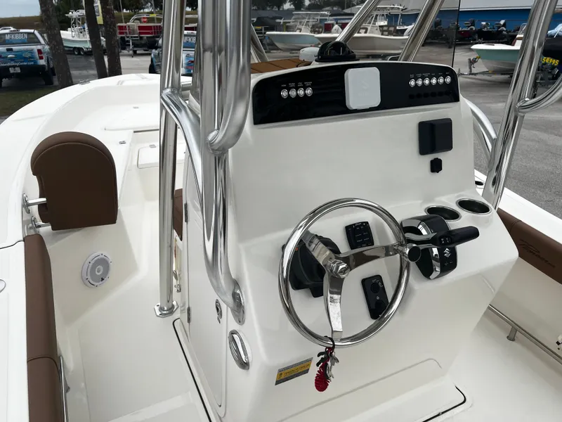 Slide: The Image of 2024 Pioneer 220 Bay Sport boat console with steering wheel and controls. - 18