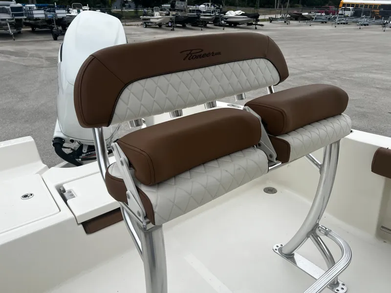 Slide: The Image of 2024 Pioneer 220 Bay Sport boat seating with brown and white upholstery. - 21