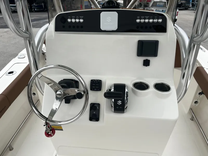 Slide: The Image of 2024 Pioneer 220 Bay Sport boat console with steering wheel and controls. - 22